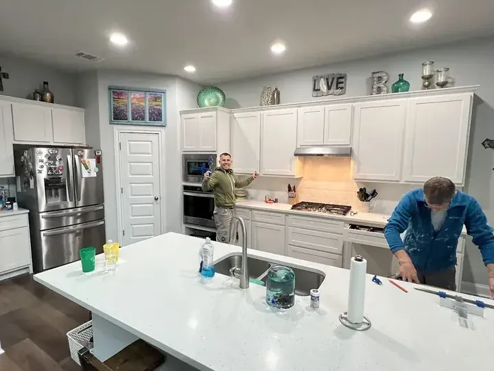 Crew restoring a kitchen after a supply hose leak