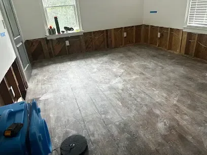 Dehumidifier and air movers drying a hallway after sewage removal